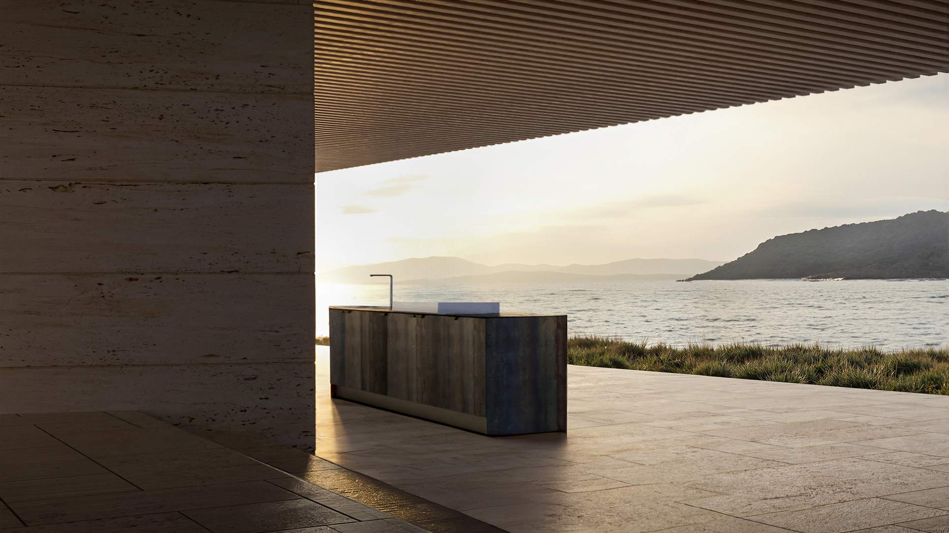 Cucina VEZZONI in acciaio sotto un portico aperto sul mare, al tramonto